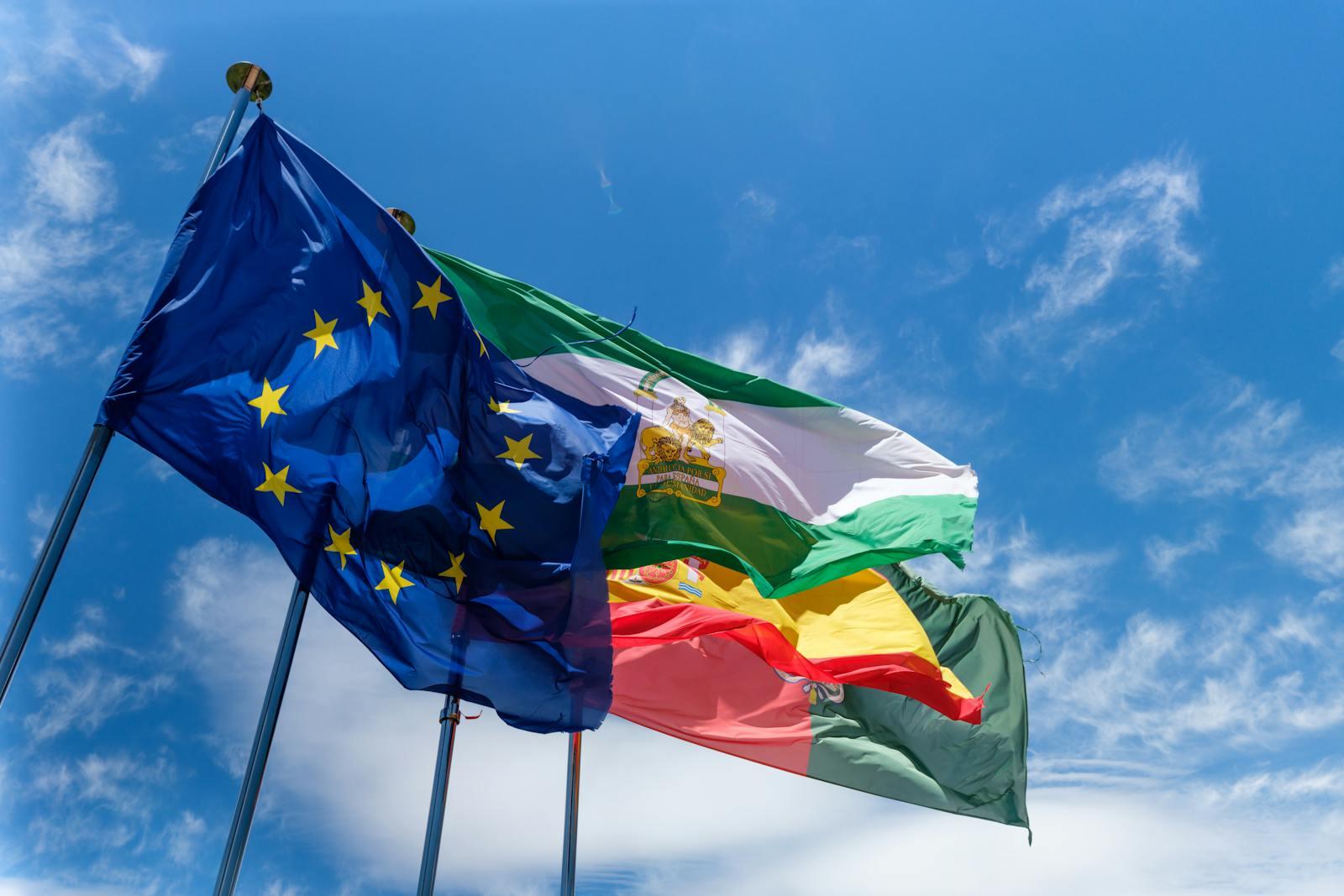 European Union flags fluttering against a blue sky.
