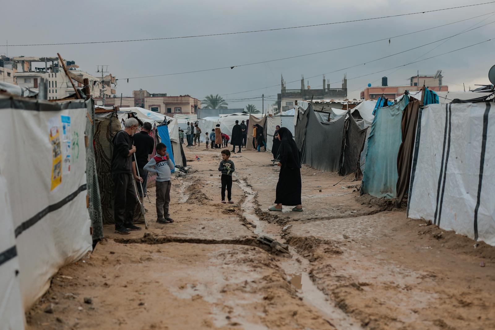 Daily life in a Gaza refugee camp amidst war damage.