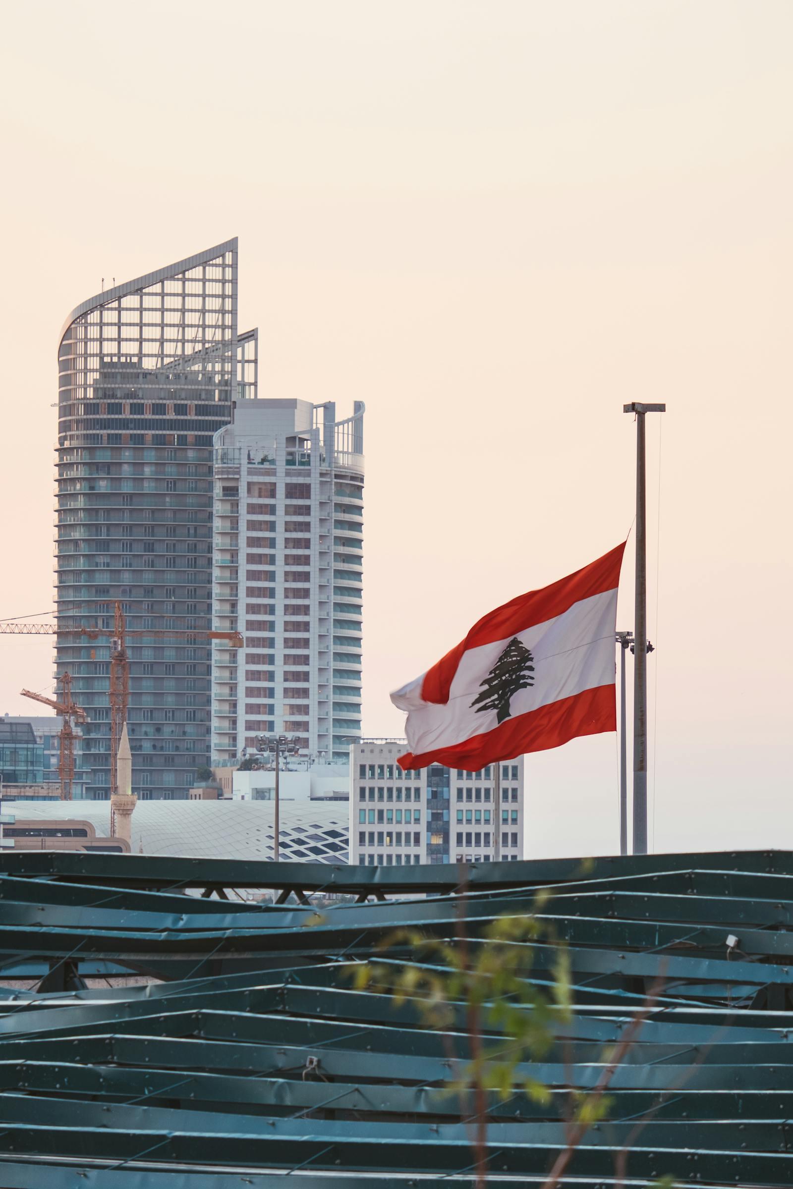 The Lebanese flag in front of Beirut's modern skyline.