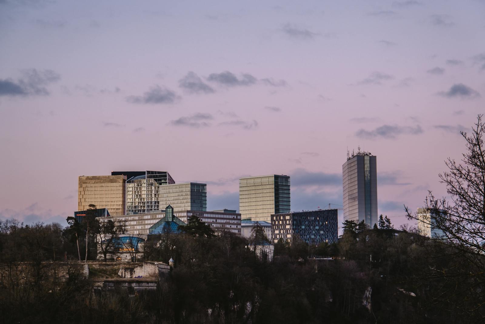 Kirchberg financial-district towers in Luxembourg City at sunset.