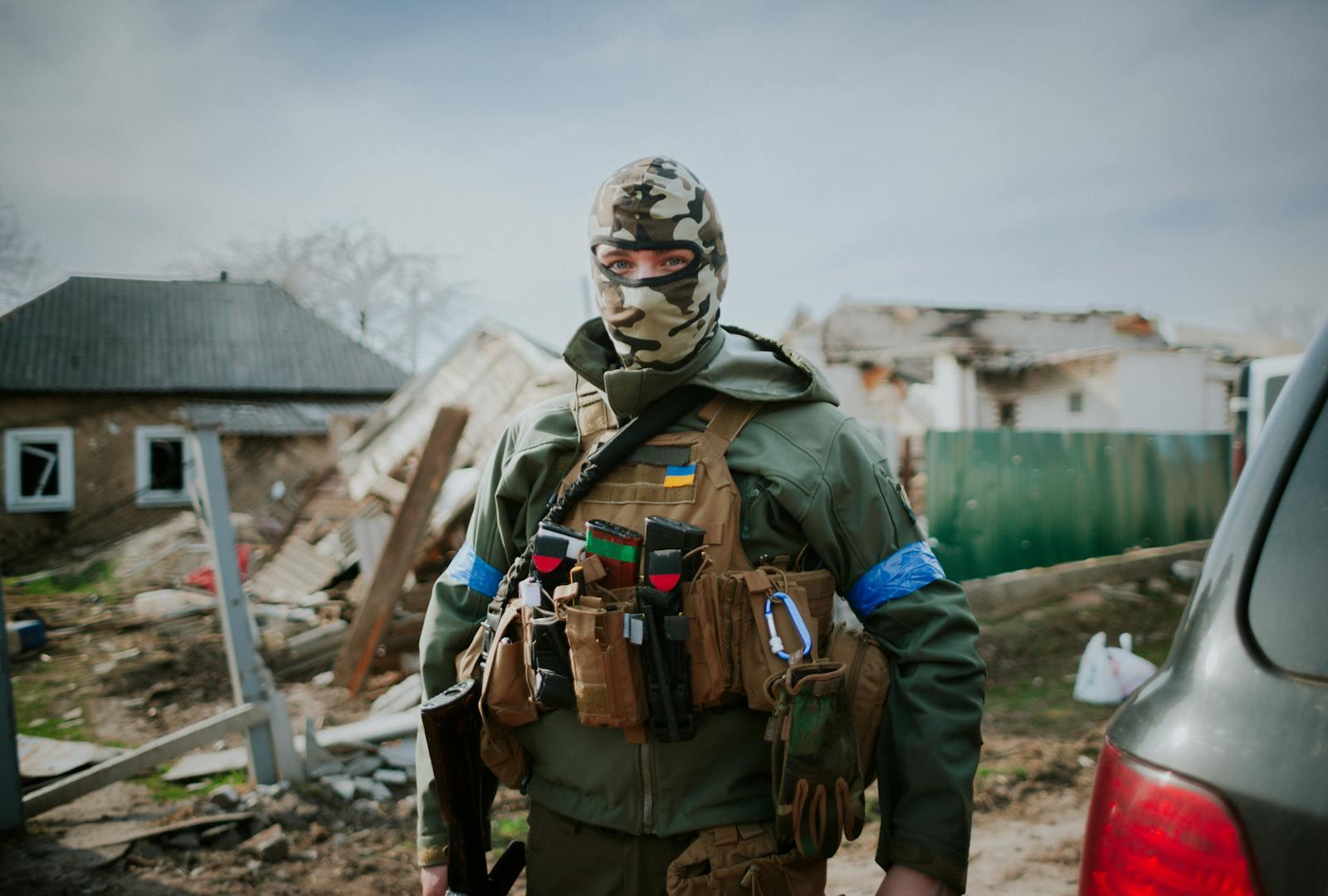 Soldier on a damaged street in Kyiv Oblast, Ukraine.
