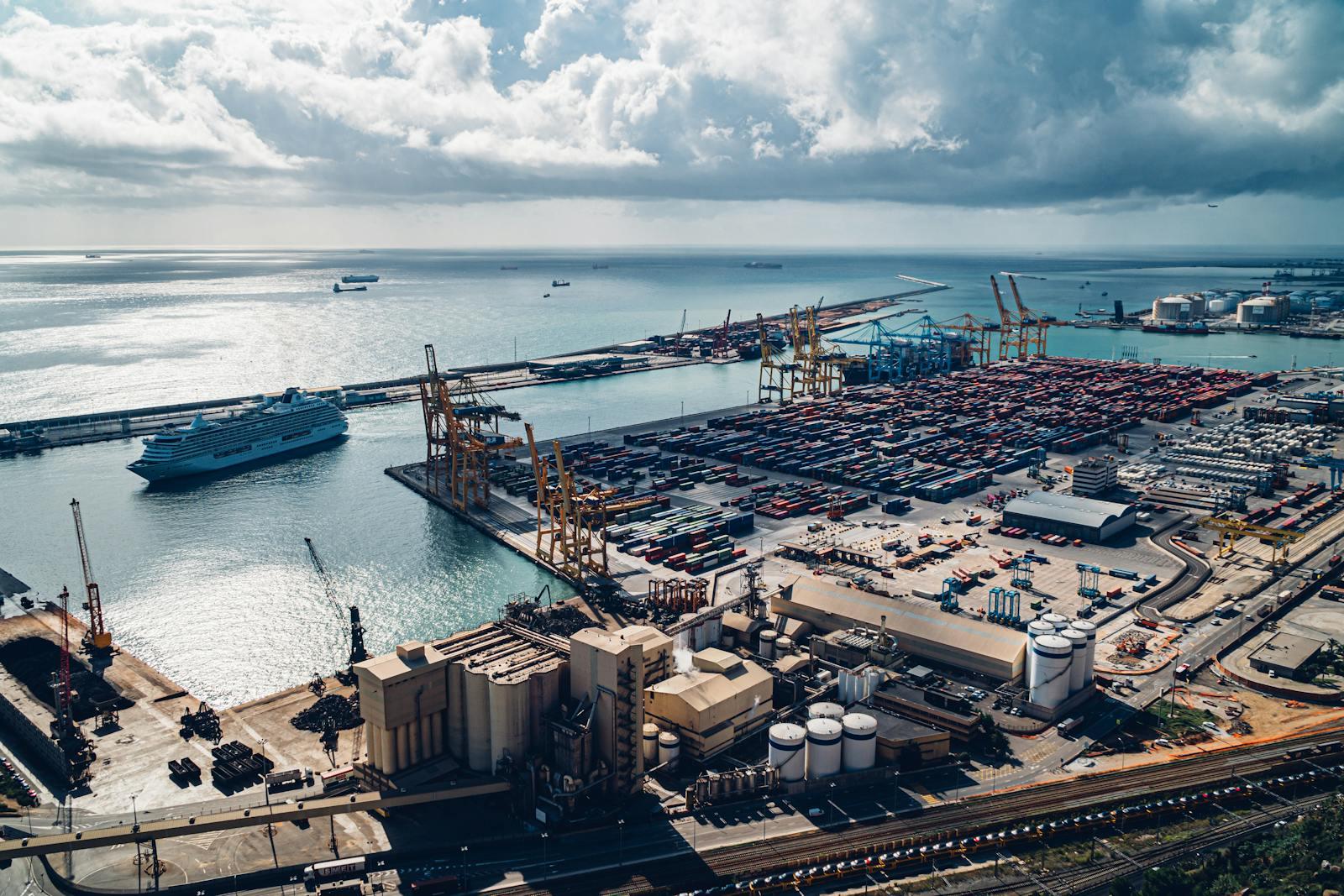 Aerial view of the Port of Barcelona with stacked shipping containers.